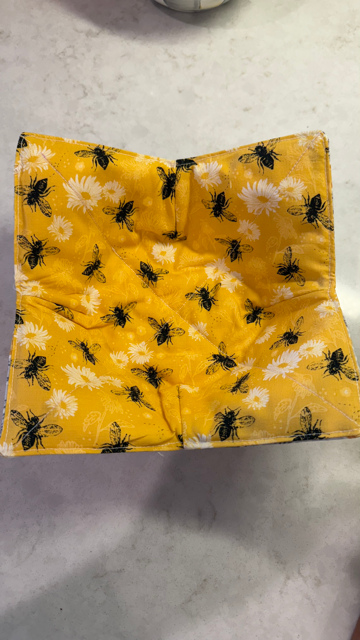 Hand-sewn bowl cozies made of 100% cotton, washable, and designed to protect hands from heat and cold. Fits most medium soup bowls.