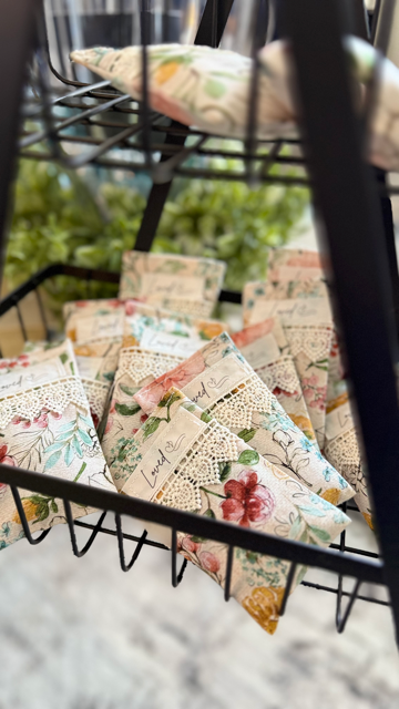 Handmade lavender sachets with floral and butterfly fabric, filled with pure lavender for a fresh, calming scent in drawers or closets.