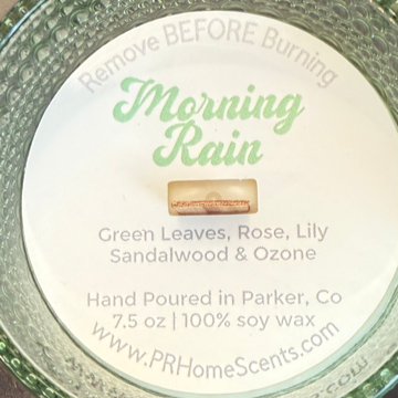 Morning Rain soy candle with green leaves, rose, lily, sandalwood, and ozone. Crackling wood wick, 40-50 hours burn time, phthalate-free.