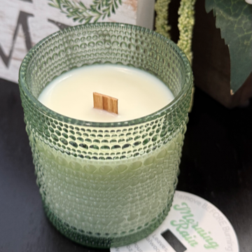Morning Rain soy candle with green leaves, rose, lily, sandalwood, and ozone. Crackling wood wick, 40-50 hours burn time, phthalate-free.