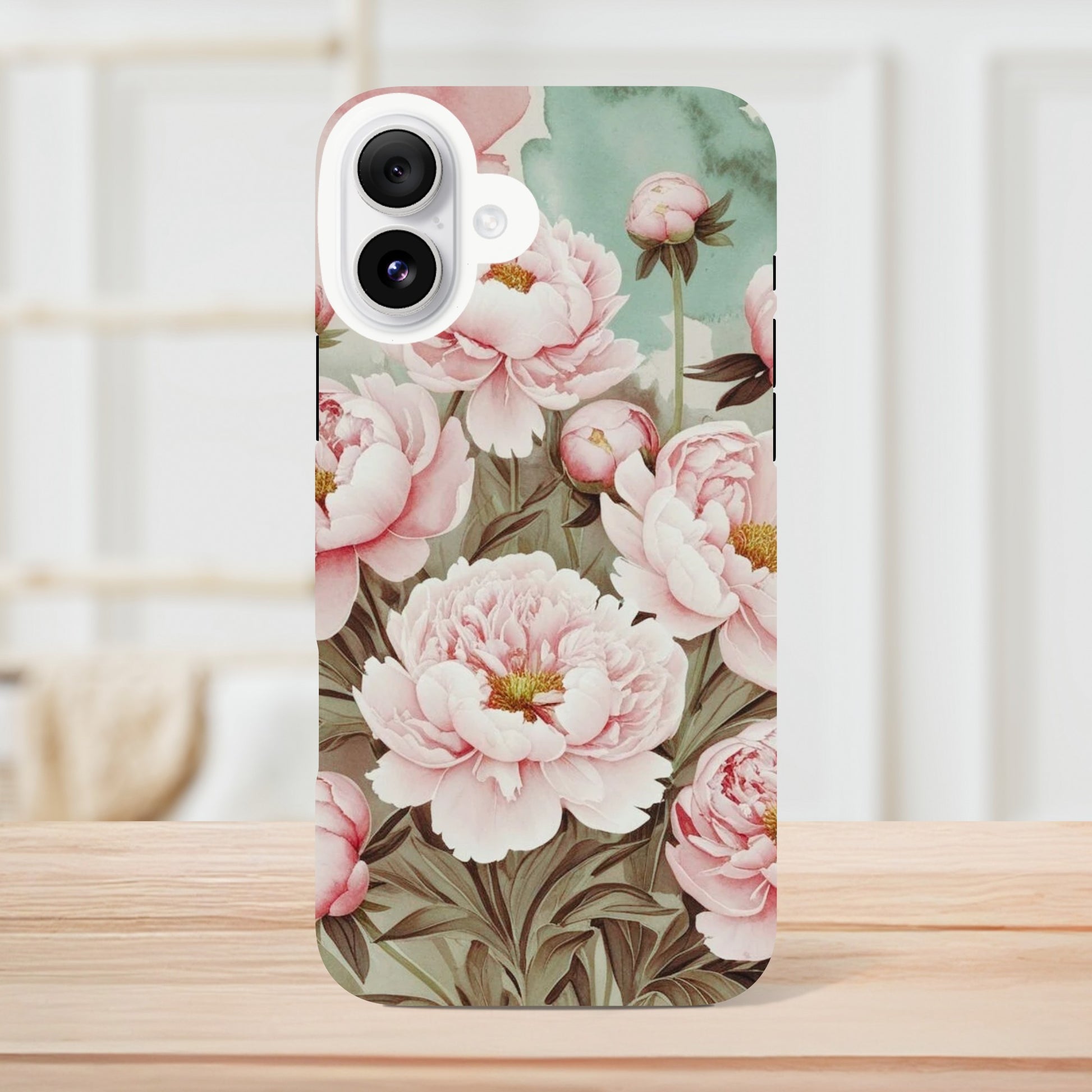 Protect your iPhone in style with a dual-layer tough case featuring pink peonies on a mint green background. Fits iPhone 12+ and supports wireless charging.